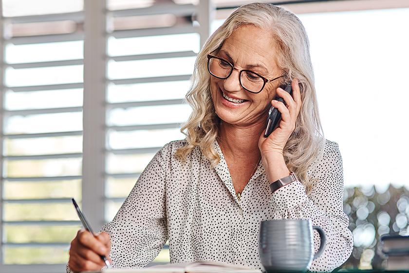 An attractive senior businesswoman taking a phonecall while working from home 